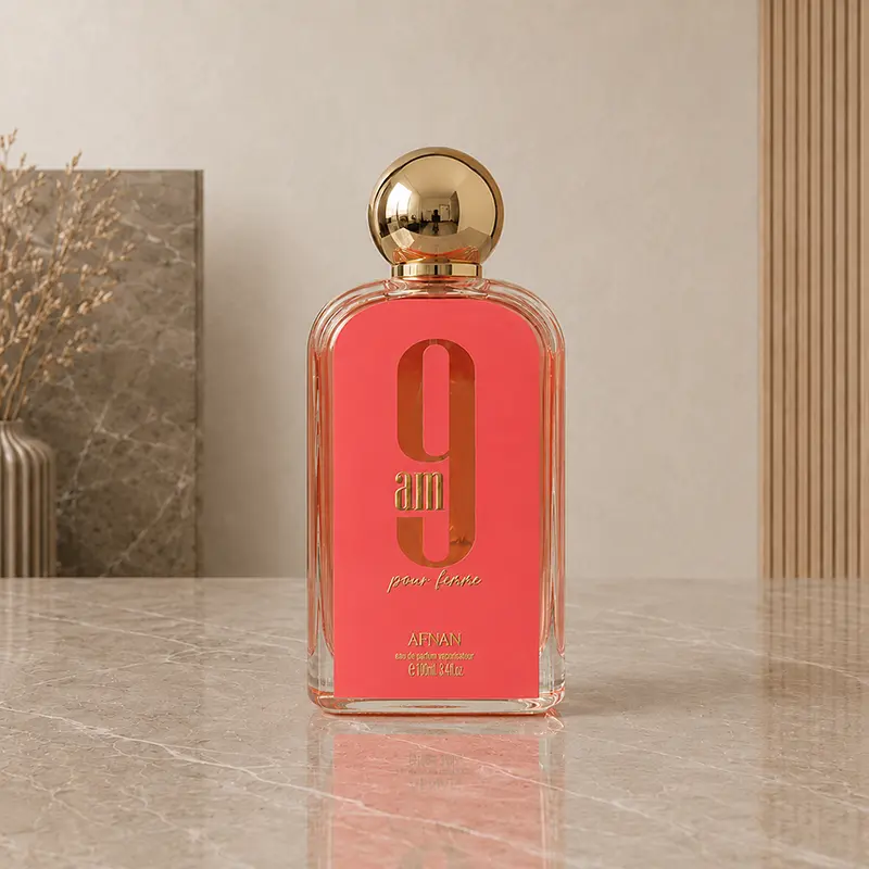 Clear Afnan 9 AM Pour Femme Eau de Parfum bottle with a pink panel and round gold cap, 100ml