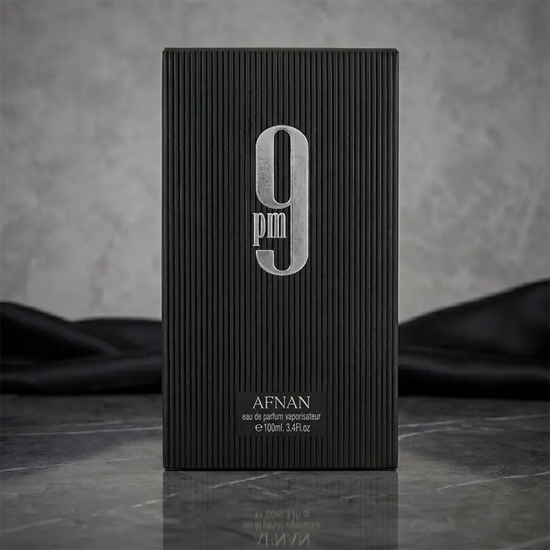 Closeup of Afnan 9 PM luxury packaging featuring embossed branding and textured black box design.