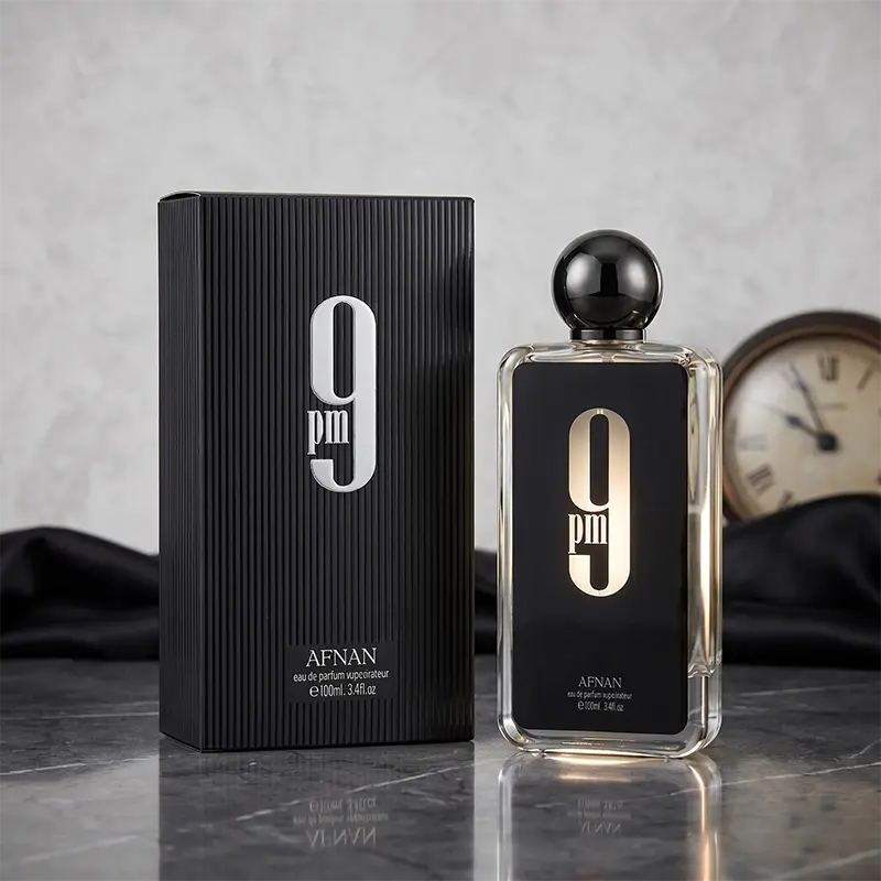 Afnan 9 PM parfum bottle and luxury box displayed together in a premium retail presentation.