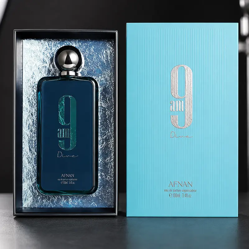 Front presentation of the Afnan 9 AM Dive eau de parfum bottle positioned next to its premium blue outer box.