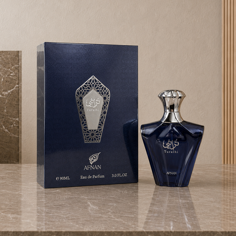 Box and navy glass Turathi Blue bottle arranged at a slight angle on a reflective marble surface.