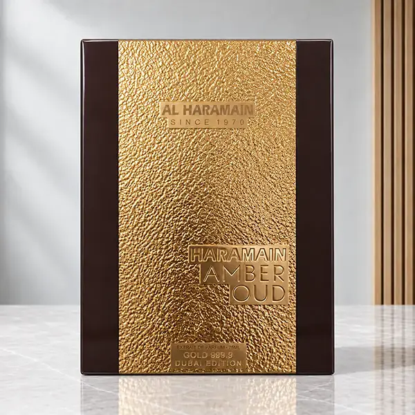 Amber Oud Gold Dubai Edition presentation box with a textured gold front and dark brown side panels.