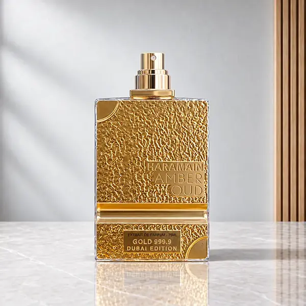 Gold-textured Amber Oud Dubai Edition perfume bottle with its cap removed to reveal the spray atomiser.