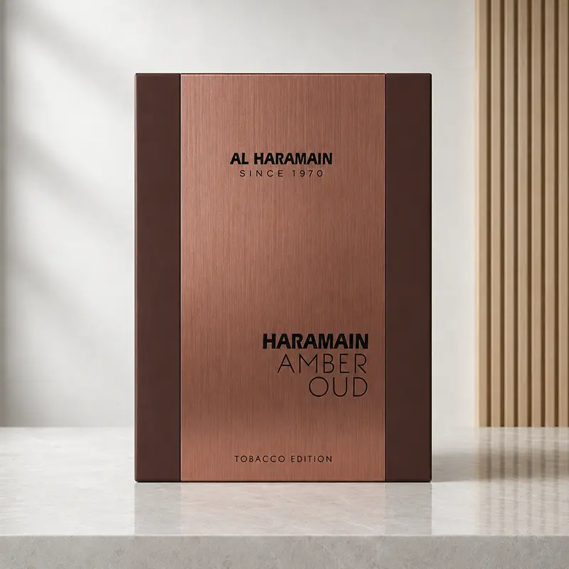 Front view of the Al Haramain Amber Oud Tobacco Edition box with copper-toned brushed finish.