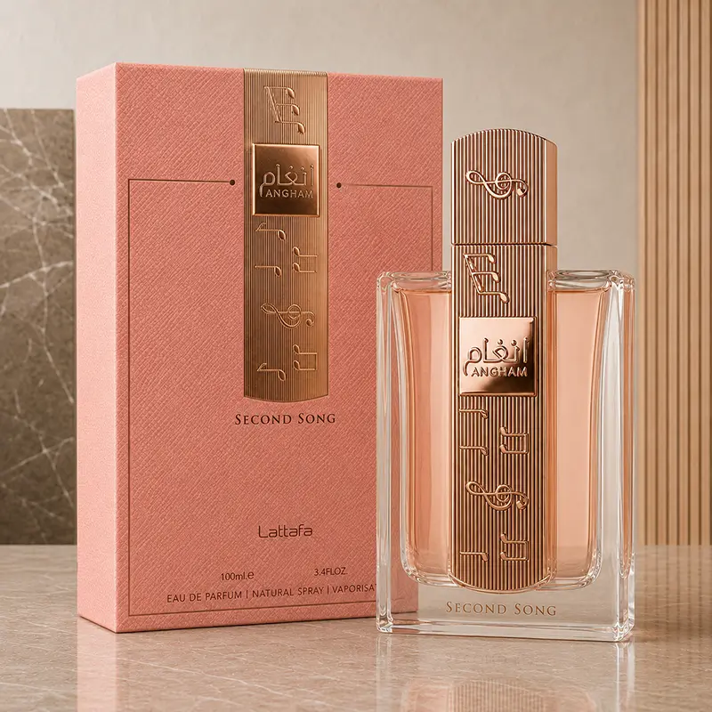 Angham Second Song perfume box and capped bottle arranged together on a marble studio surface.