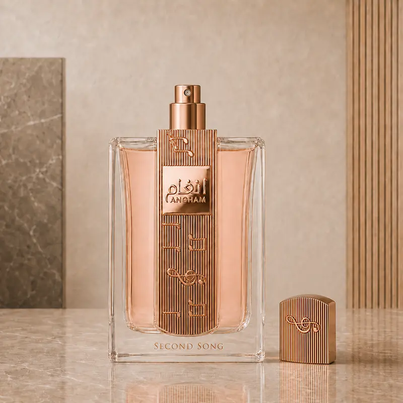 Uncapped Angham Second Song bottle with its exposed spray nozzle and ribbed cap placed beside it.