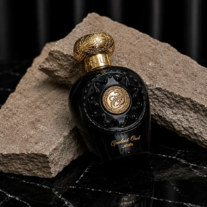 Close view of the raised gold Arabic calligraphy and floral patterns engraved on the glass.