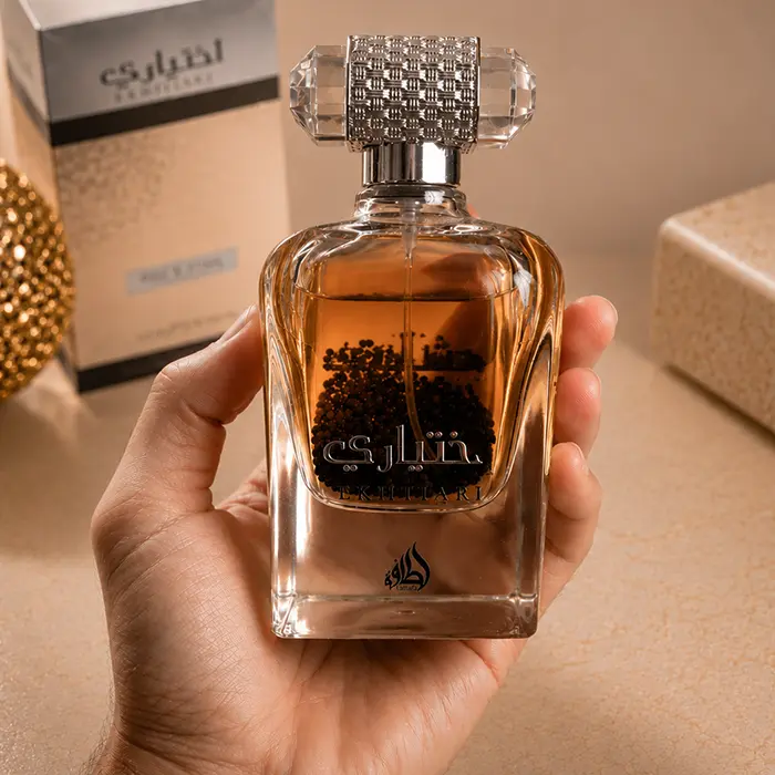 Lifestyle presentation showing the Lattafa Ekhtiari parfum bottle held in hand to display true scale.