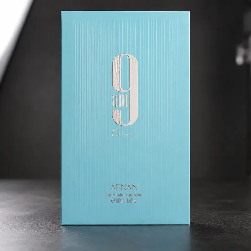 Exterior luxury blue packaging of the 9 AM Dive fragrance by Afnan, highlighting the elegant embossed branding.