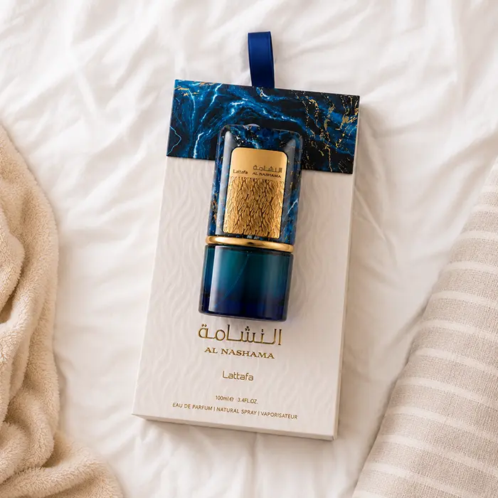 Lifestyle shot featuring the Lattafa Al Nashama Caprice scent resting elegantly on a soft white bed setup.