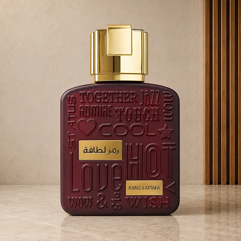 Ramz Lattafa Gold burgundy bottle with embossed lettering, gold plaques and a geometric gold cap.