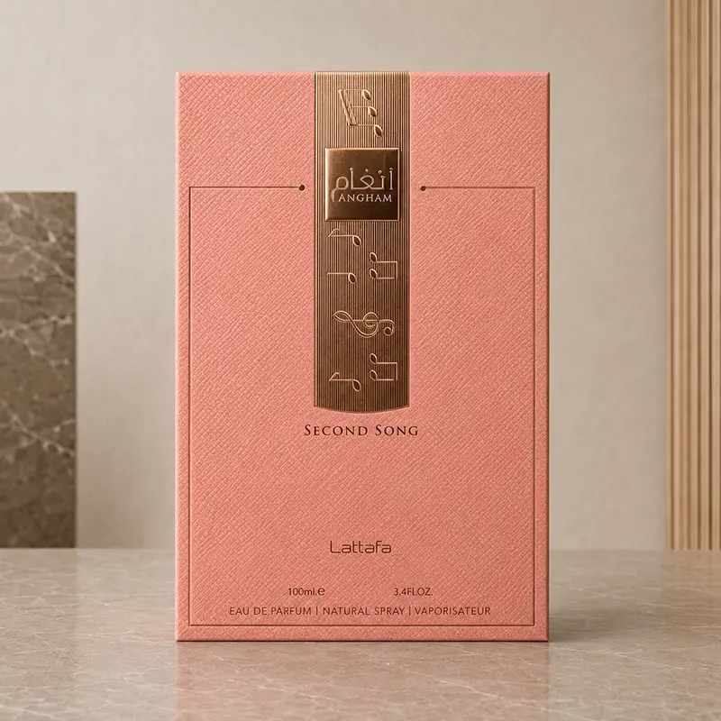 Coral-pink Lattafa Angham Second Song box with a rose-gold embossed panel in a neutral studio.