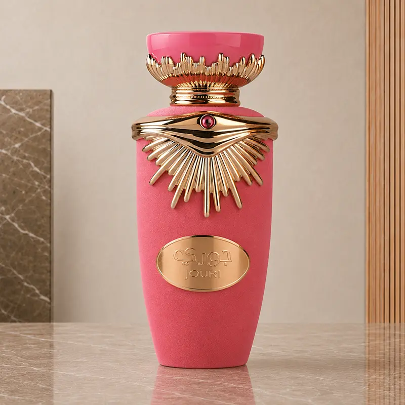 Rose-gold detailing and a textured pink finish are visible on the upright Lattafa Jouri perfume bottle.