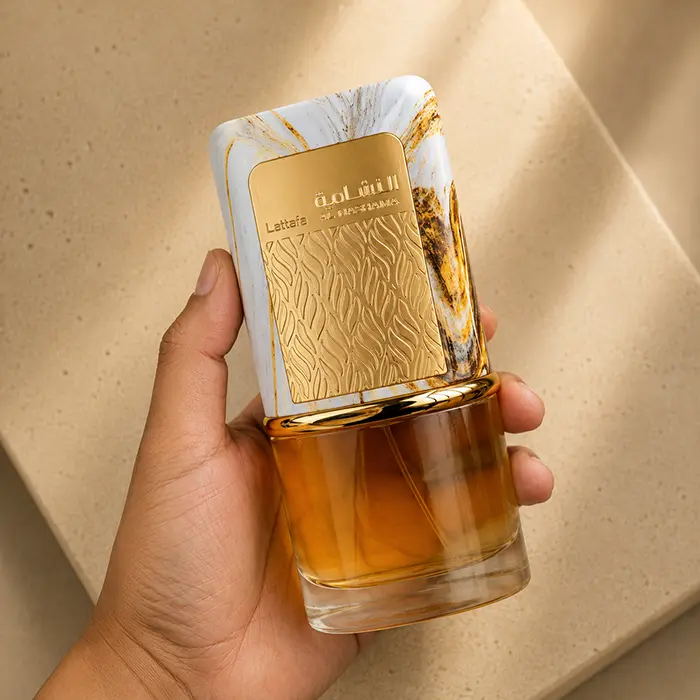Showcasing the tactile scale and marble cap finish of Lattafa Al Nashama for women and men.