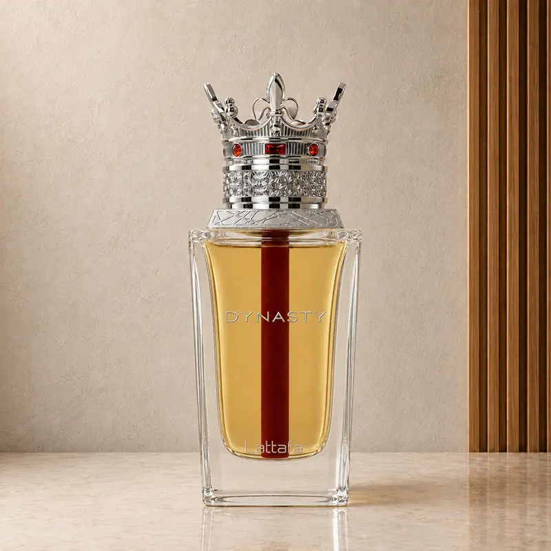 Clear Dynasty perfume bottle with amber liquid, crown cap and silver front lettering