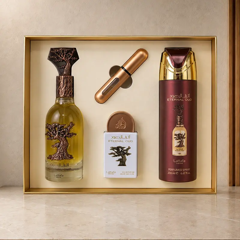 Open Eternal Oud presentation tray holding two EDP bottles, perfumed spray and rose-gold atomiser