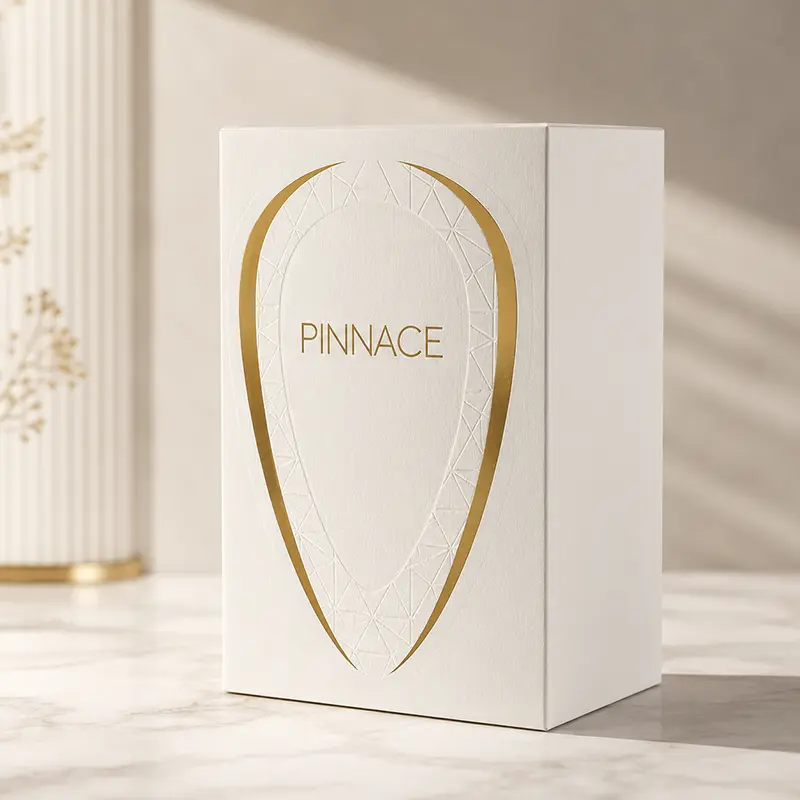 Angled luxury packaging view of Pinnace Blanc parfum box with embossed gold branding details.