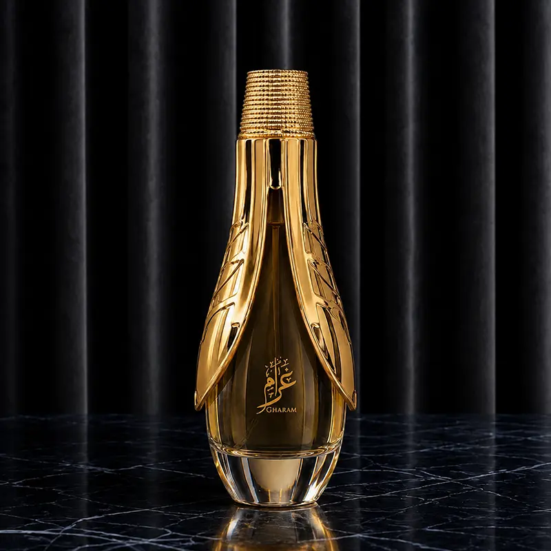 Heavy geometric clear glass bottle of Gharam EDP for women showcasing the golden liquid and brand text.