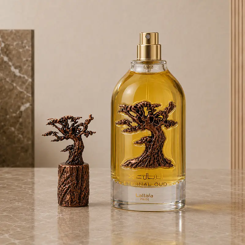 Gold spray nozzle exposed on the Eternal Oud bottle, with the bronze tree-shaped cap placed beside it