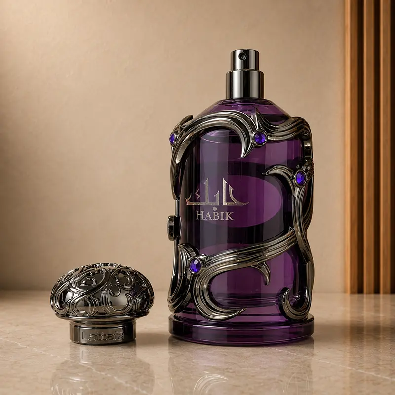 Purple Habik bottle with the cap removed, showing the metal atomiser and ornate cap beside it.