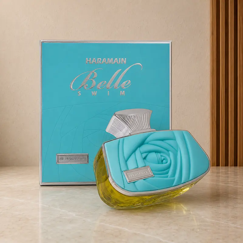 Belle Swim bottle tilted against its turquoise box in the gallery studio