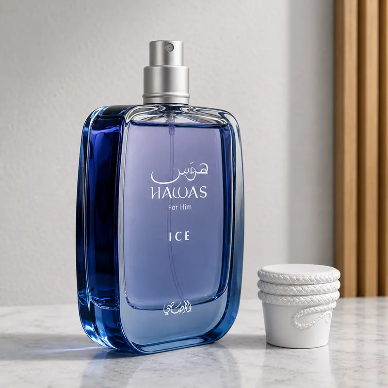 Uncapped Hawas Ice bottle at an angle with silver atomiser visible and white cap placed beside it.