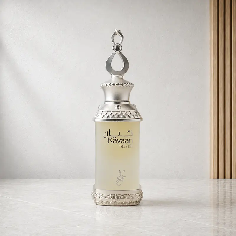 Kayaan Silver 20ml perfume oil bottle with silver ornament and pale cream body in a studio setting