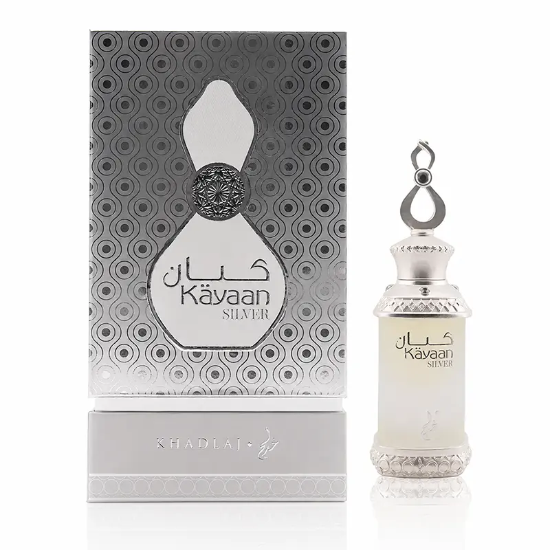 Kayaan Silver perfume oil bottle beside its silver patterned presentation box on a white background