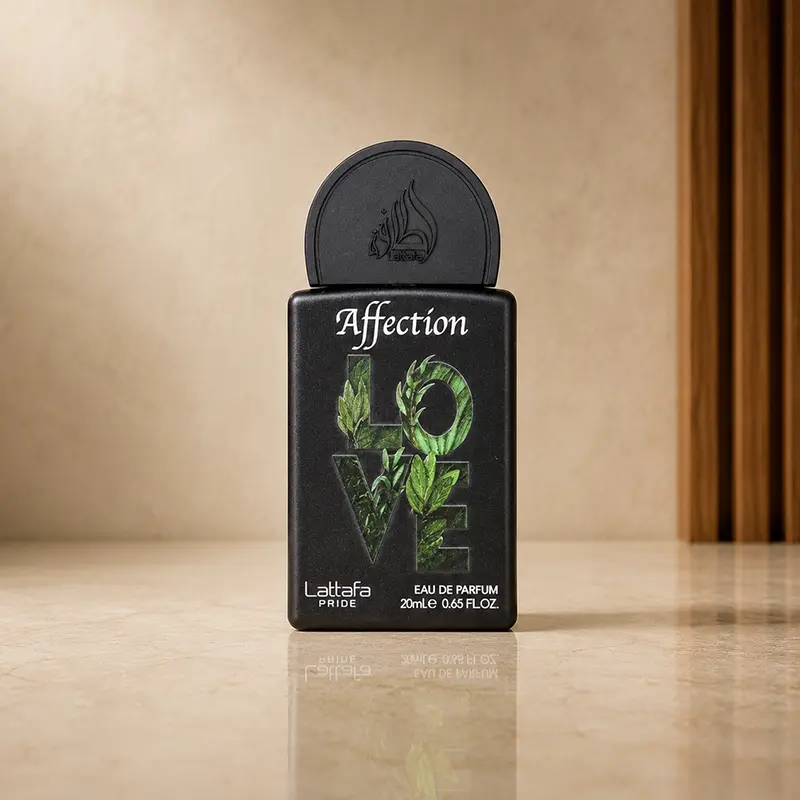 Small black Lattafa Affection Eau de Parfum bottle with green LOVE leaf artwork on a beige surface.