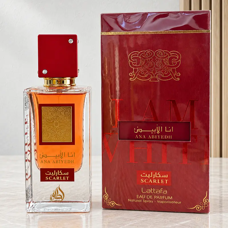 Lattafa Ana Abiyedh Scarlet perfume bottle and red box displayed side by side.