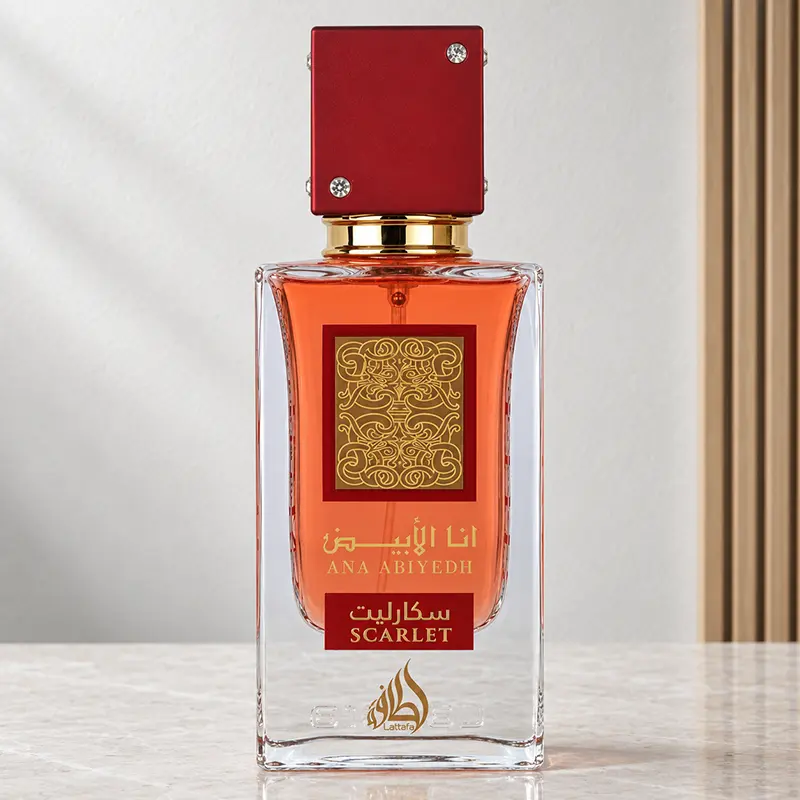 Lattafa Ana Abiyedh Scarlet perfume bottle with red cap and orange-red fragrance in front view.