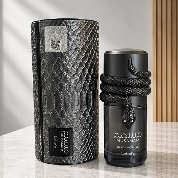 Presentation case beside the Musamam Black Intense bottle, both shown upright at a natural studio angle.
