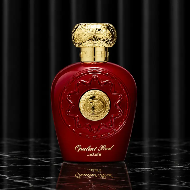 Detailed shot of the geometric red perfume flacon highlighting its heavy metallic structural build.