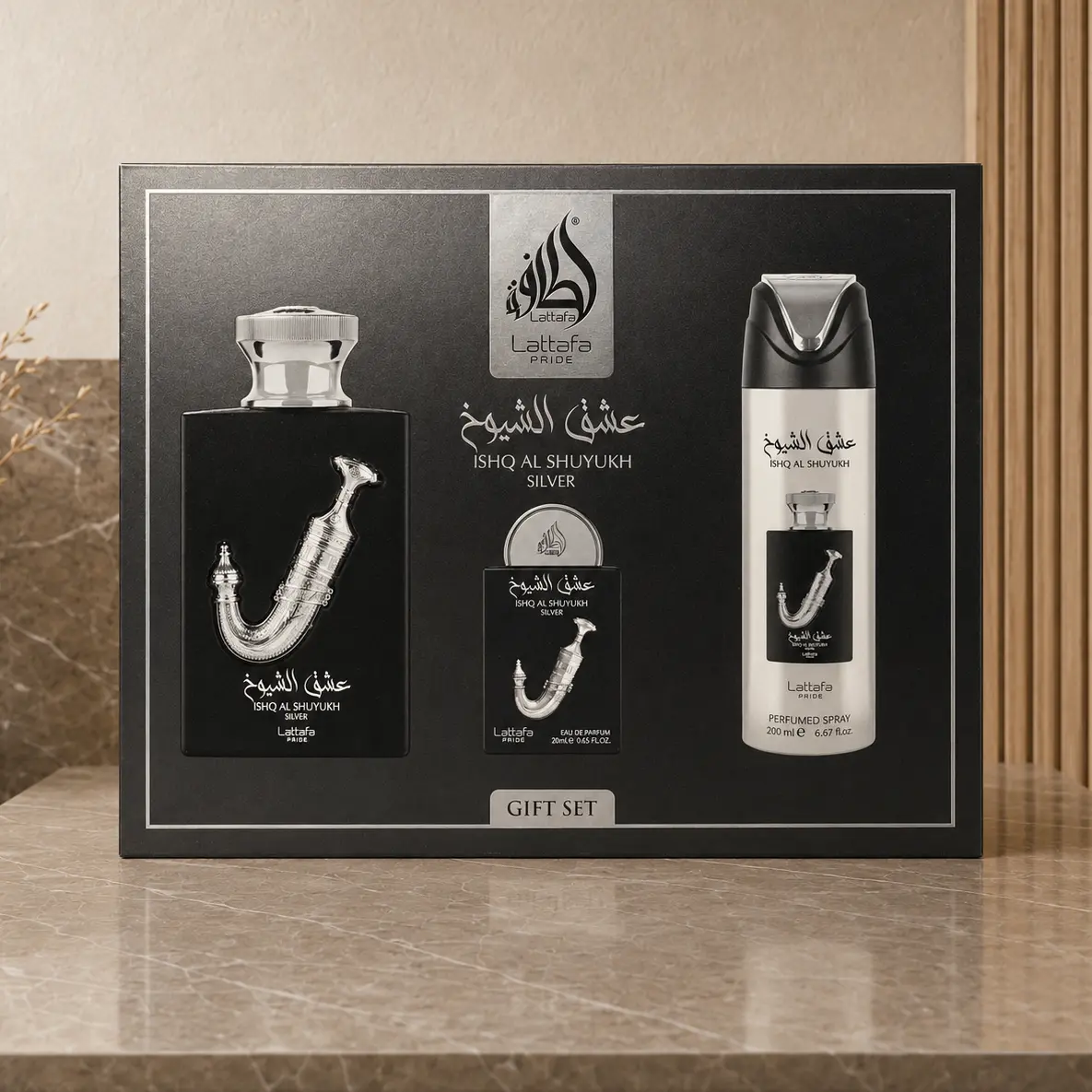 Lattafa Pride Ishq Al Shuyukh Silver gift box with product images on a black and silver front panel.