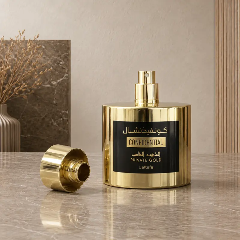 Confidential Private Gold spray bottle with the cap removed beside the nozzle.