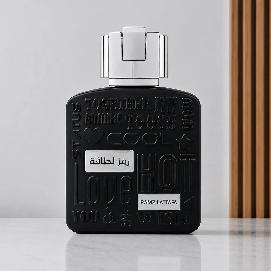 Ramz Lattafa Silver black embossed bottle with reflective silver cap in a front studio view.