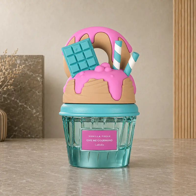 Lattafa Vanilla Freak bottle with a turquoise base and pink dessert-shaped cap.