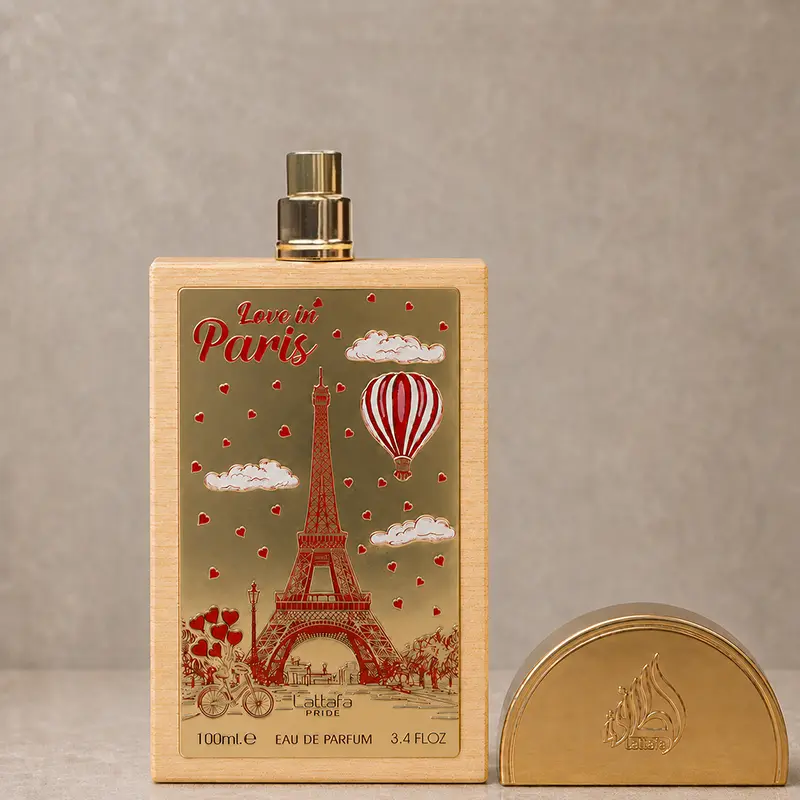Love In Paris bottle with spray nozzle exposed and its gold-tone semicircular cap beside it
