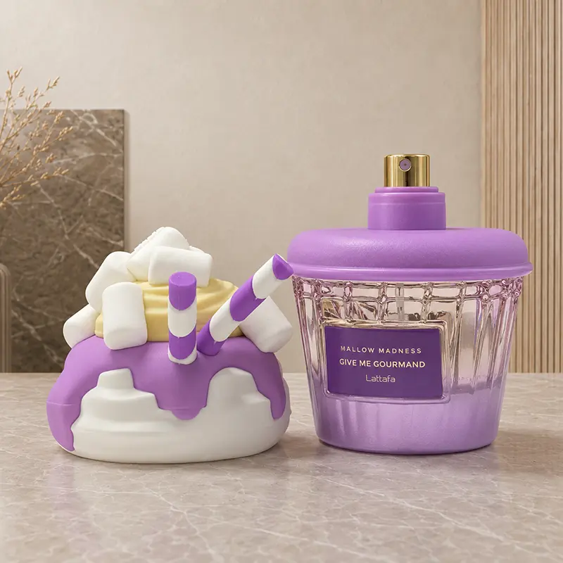 Removed dessert-shaped cap sits beside the Mallow Madness bottle with its gold spray nozzle exposed.