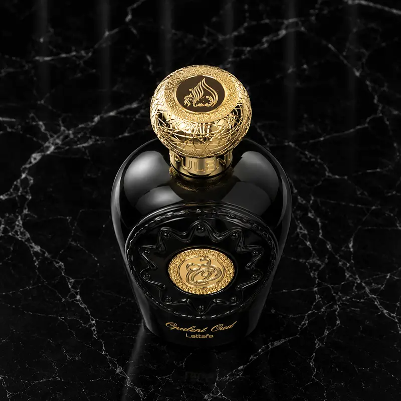 Detailed view of the heavy metallic gold cap and intricate neck collar cords on the bottle.