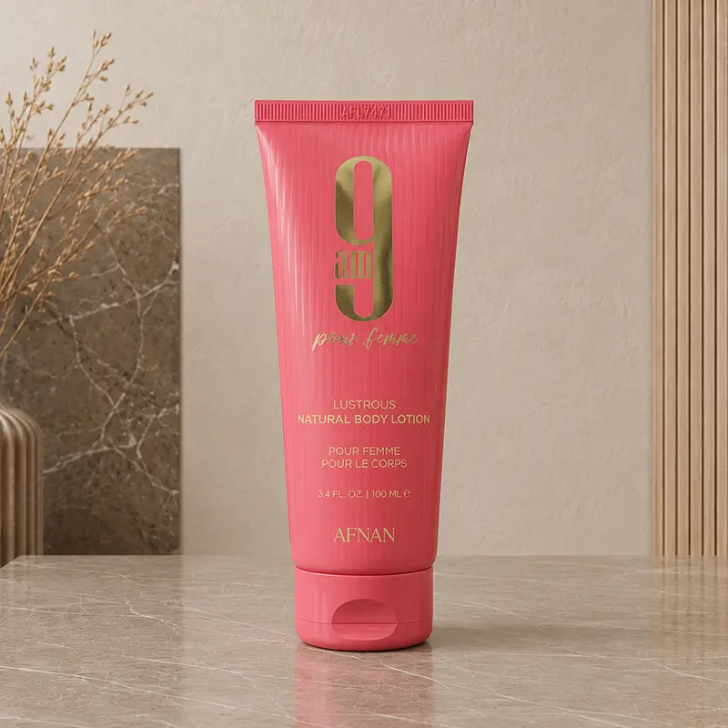 Pink Afnan 9 AM Pour Femme Natural Body Lotion tube with gold branding, 100ml