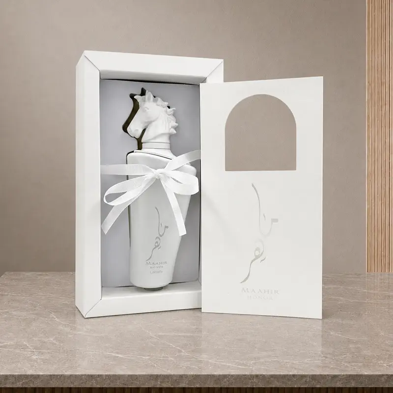 Open Maahir Honor inner box holding the white bottle with ribbon and removable front panel.