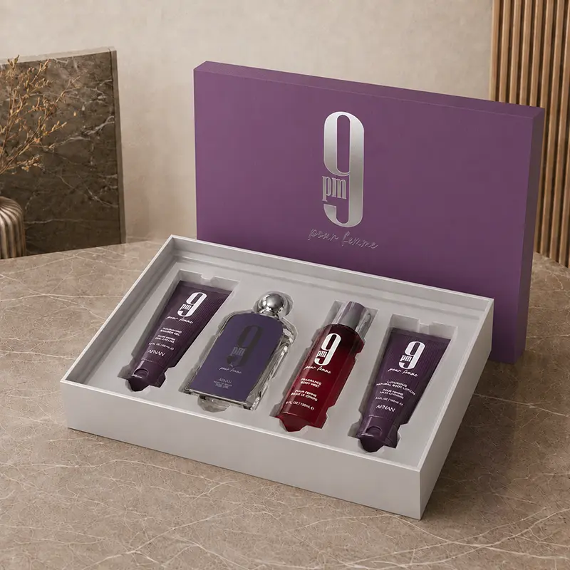 Open purple Afnan 9 PM Pour Femme box with four products arranged in a white insert.
