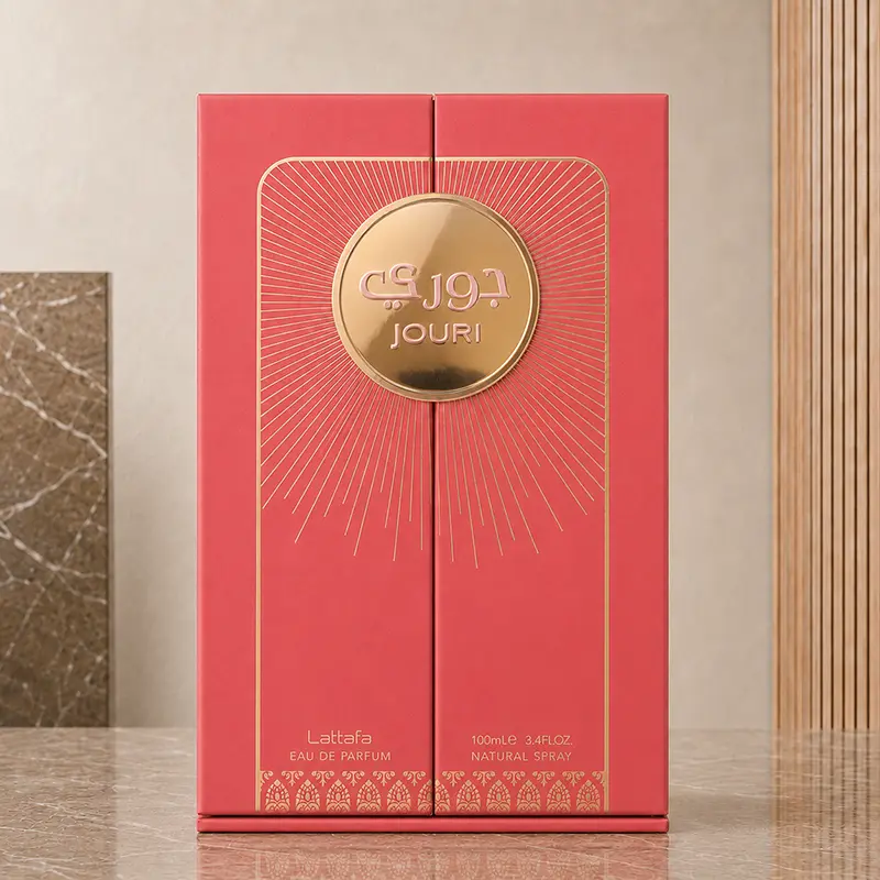 Closed Lattafa Jouri presentation box with coral panels, radiating gold lines and a round central medallion.