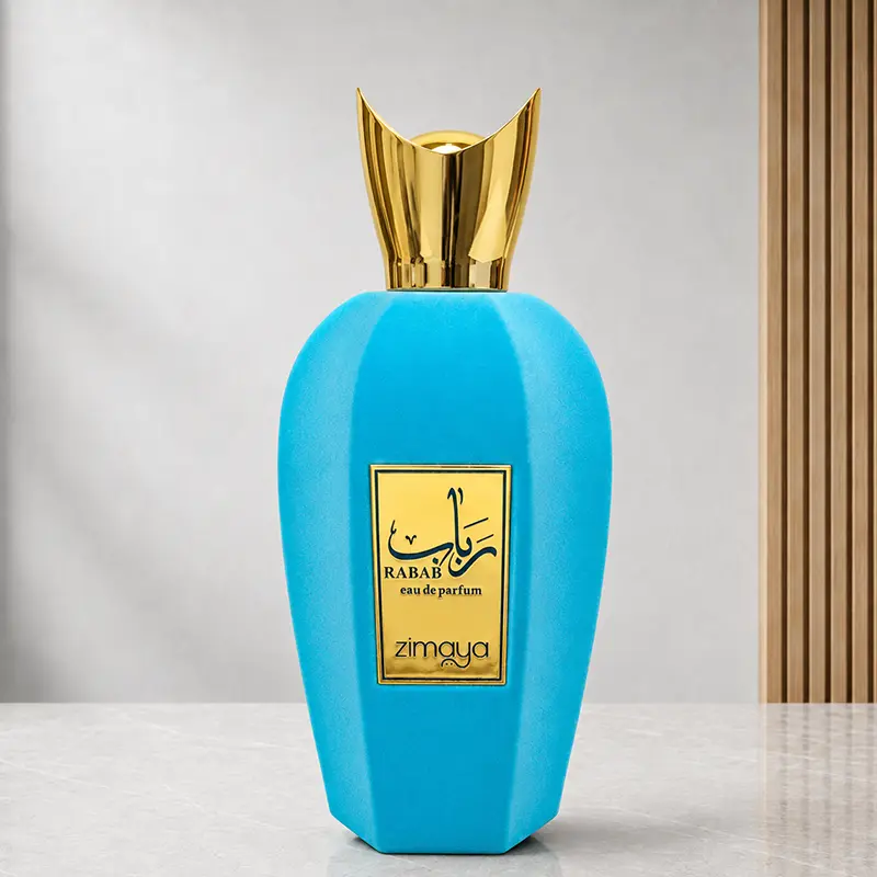 Zimaya Rabab Blue turquoise bottle with reflective gold cap and front plaque in studio.