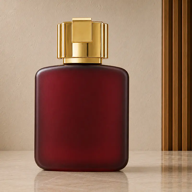Plain burgundy back of Ramz Lattafa Gold bottle with rounded edges and a reflective gold cap.