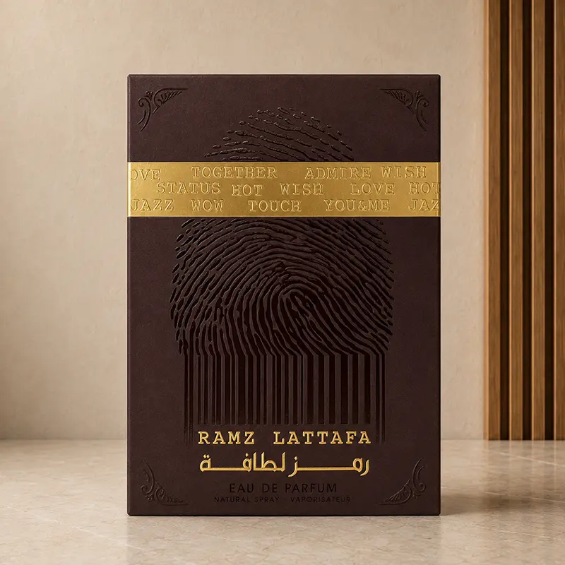 Ramz Lattafa Gold box front with fingerprint motif, gold band and Eau de Parfum text.