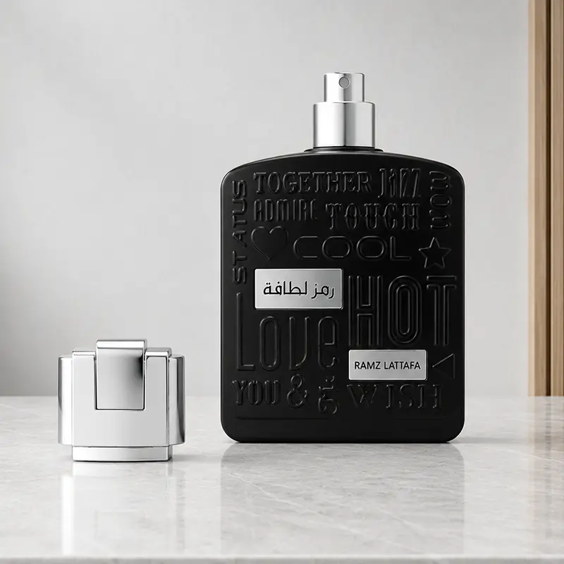 Ramz Lattafa Silver uncapped bottle showing the silver atomizer with the cap placed beside it.