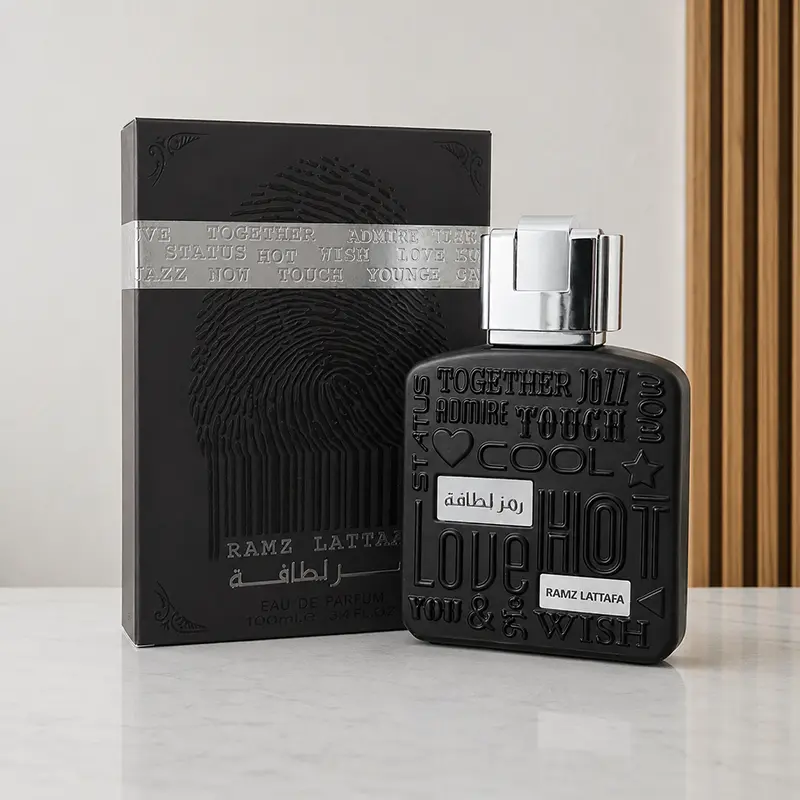 Ramz Lattafa Silver box and bottle photographed together at an angled studio view.