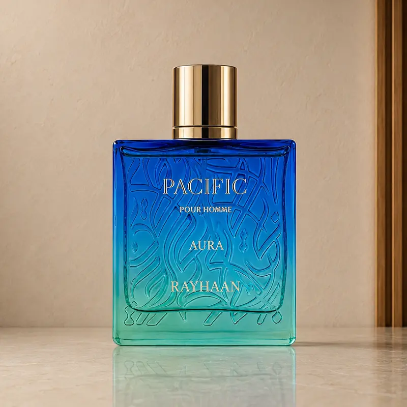Rayhaan Pacific Aura blue-green perfume bottle with gold cap on a neutral interior background.